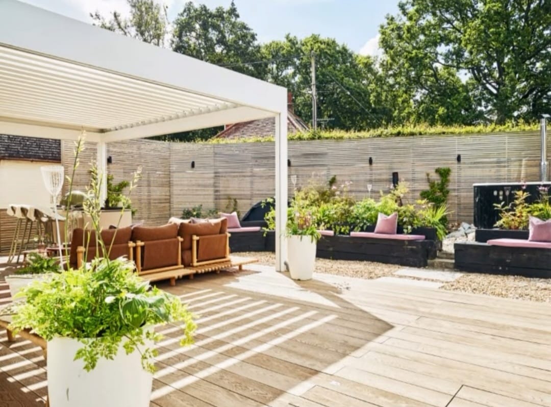 Another view of the outdoor lounge with lush plants