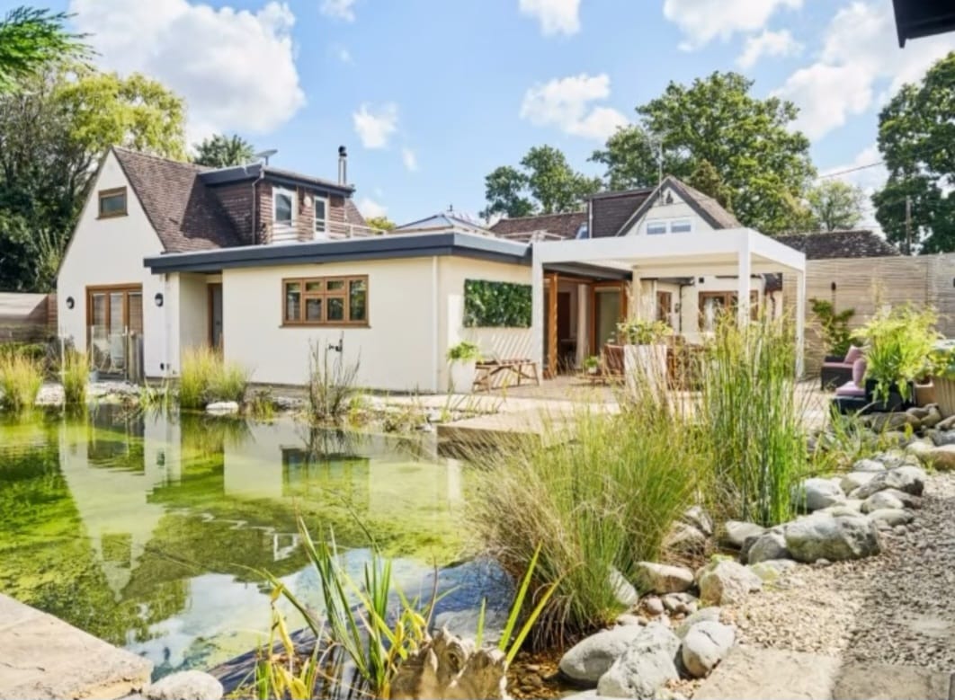 Exterior view of the retreat building with a large pond